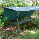 DD Hammocks 3x3 Tarp setup in a forest for bushcraft and hammock shelter.